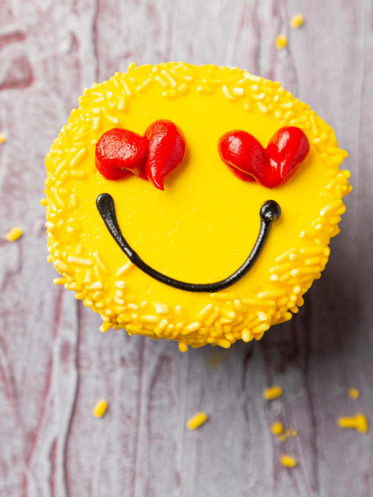 Yellow smile cupcake with red heart eyes depicting Nutrition Counseling