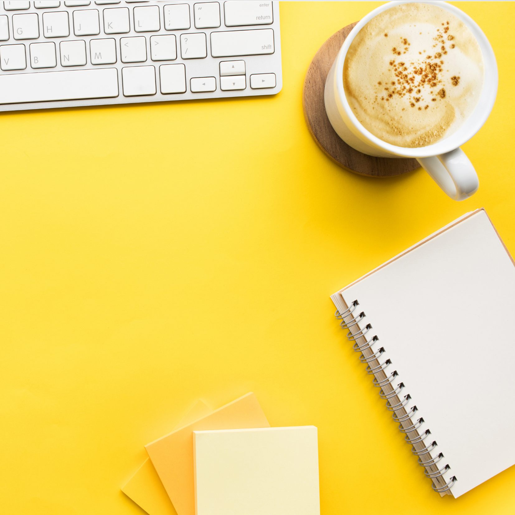 Coffee, Notebook & Keyboard on Yellow Background depicting Consulting for Van Dusen Nutrition