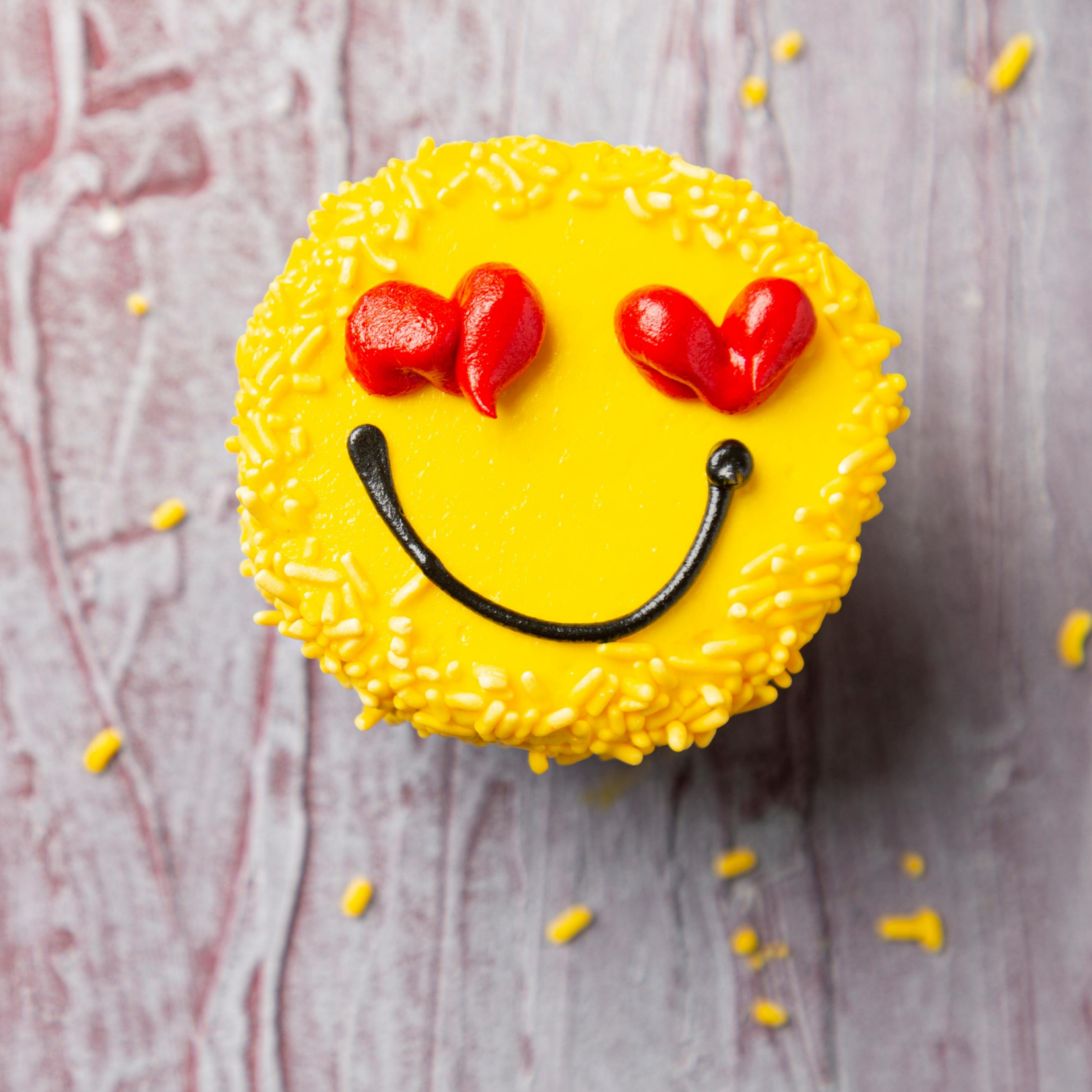 Yellow smile cupcake with red heart eyes depicting Nutrition Counseling