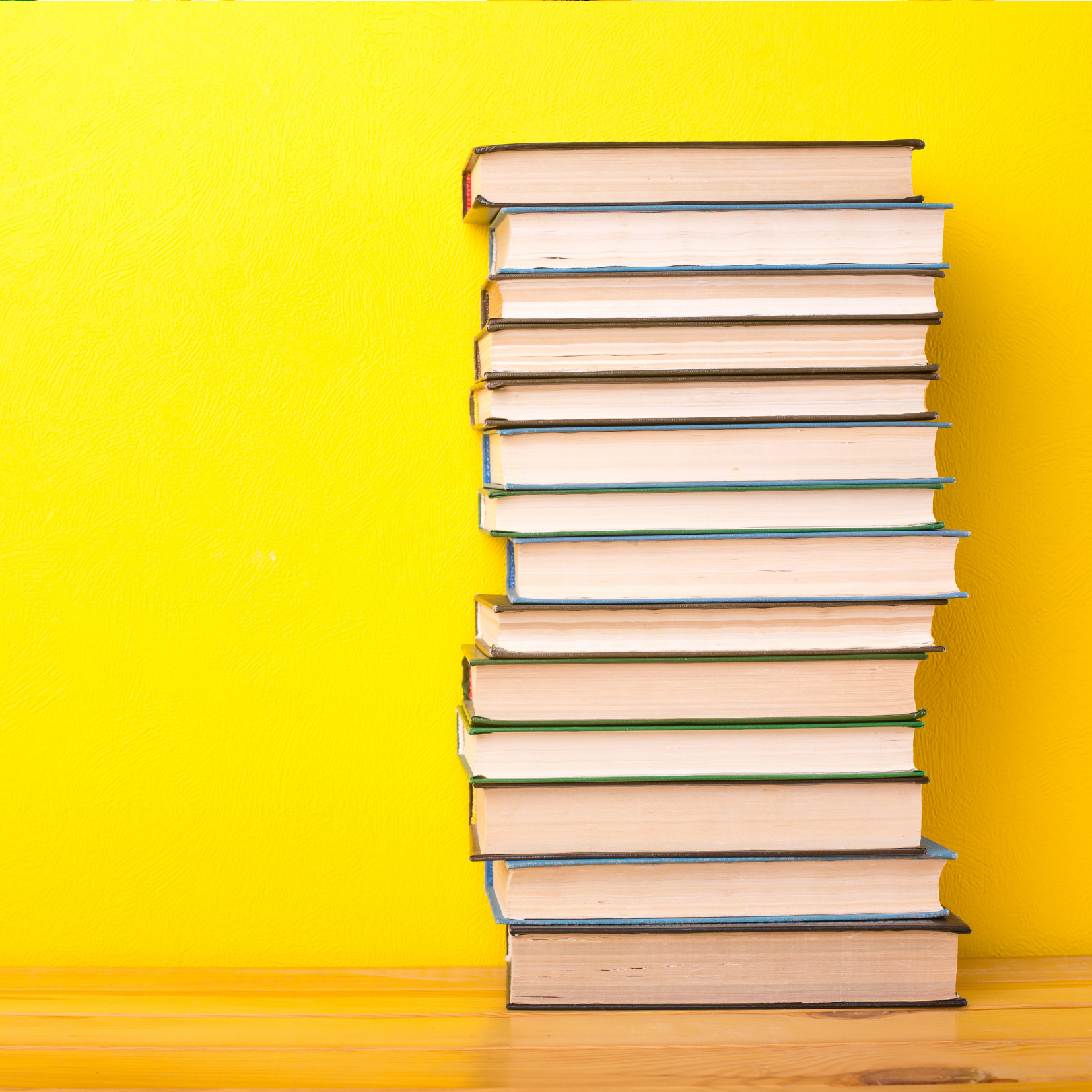 Stack of books on yellow background depicting Consulting