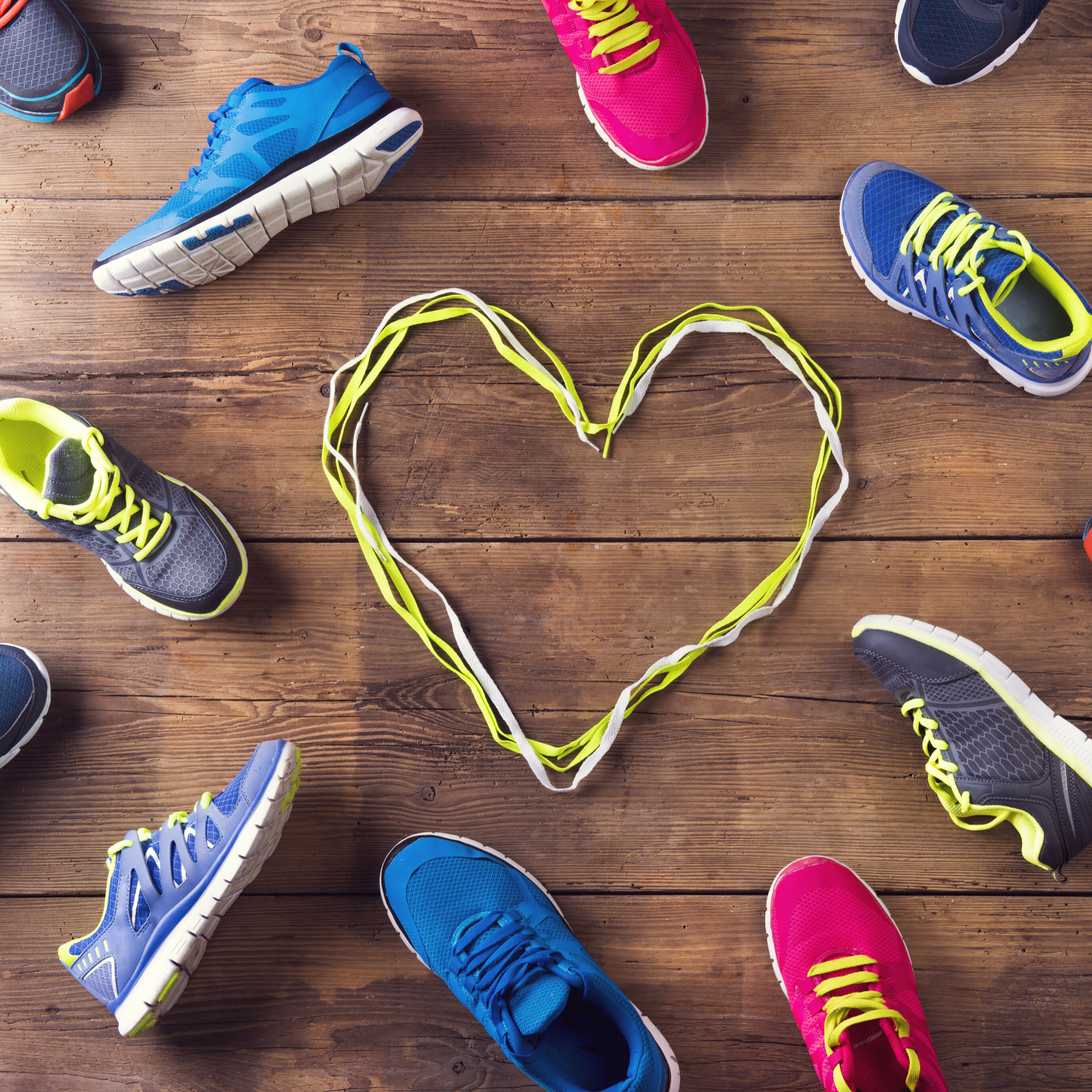 Sneakers on floor with heart in the center made of laces depicting Sports Nutrition