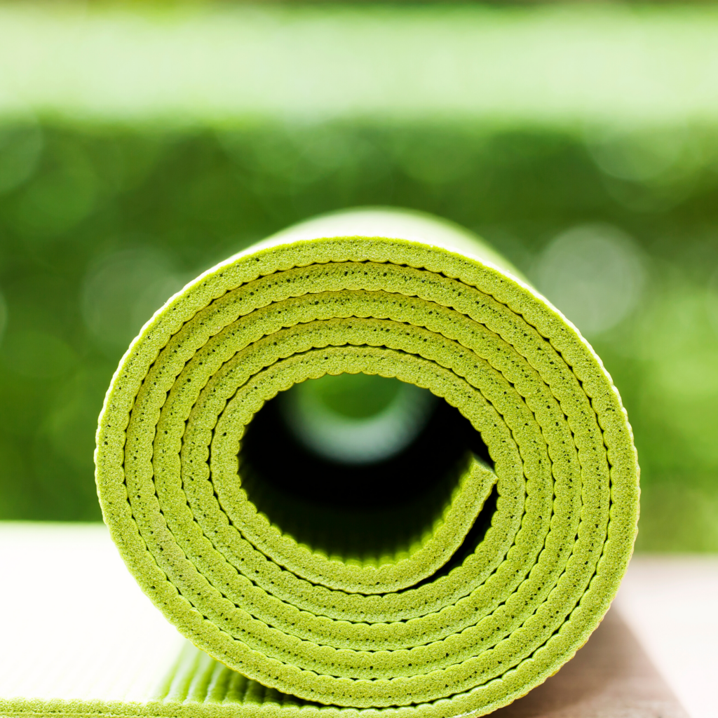 rolled up lime green yoga mat